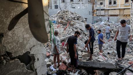People search through the rubble following Israeli airstrikes in Rafah on Sunday.