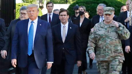 In this June 1, 2020 file photo, President Donald Trump departs the White House to visit outside St. John&#39;s Church, in Washington. Walking behind Trump from left are, Attorney General William Barr, Secretary of Defense Mark Esper and Gen. Mark Milley, chairman of the Joint Chiefs of Staff. 