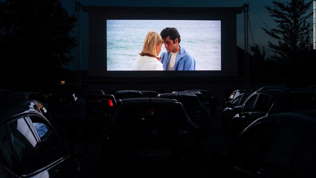 People in Ptuj, Slovenia, watch &quot;Grease&quot; at a drive-in movie theater in 2020.