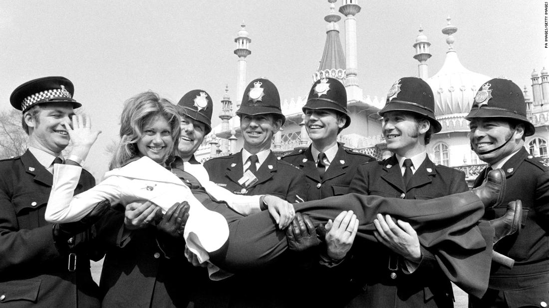 Newton-John is held by police officers in Brighton, England, where she was rehearsing for the 1974 Eurovision Song Contest.