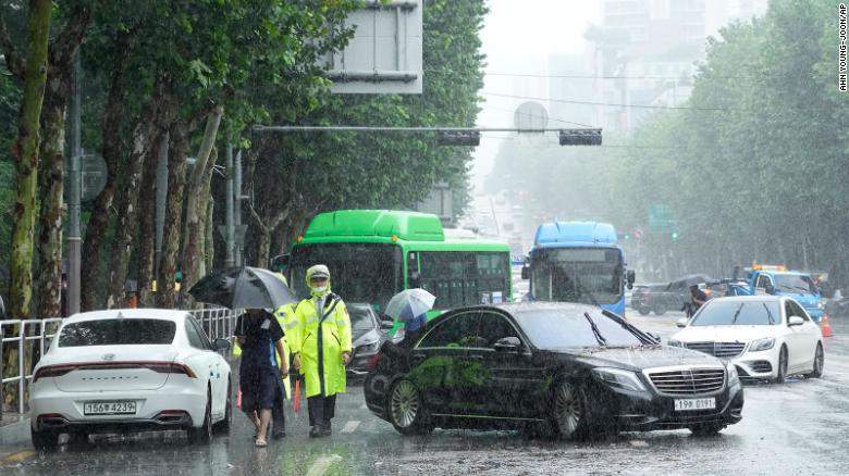 Vehicles that had been submerged by heavy rainfall block a road in Seoul, South Korea on August 9.