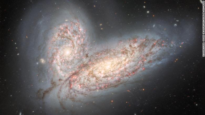 The Gemini North telescope captured a pair of galaxies, NGC 4567 (top) and NGC 4568 (bottom), as they collide. Nicknamed the Butterfly galaxies, they will eventually merge as a single galaxy in 500 million years.