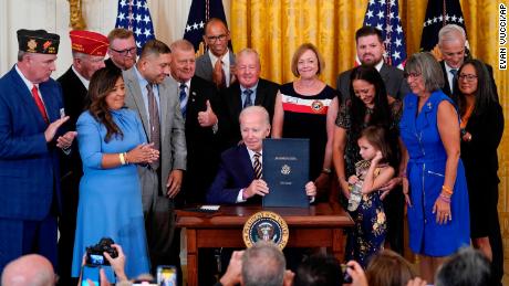 President Joe Biden holds the &quot;PACT Act of 2022&quot; after signing it during a ceremony in the East Room of the White House, Wednesday, Aug. 10, 2022, in Washington. (AP Photo/Evan Vucci)