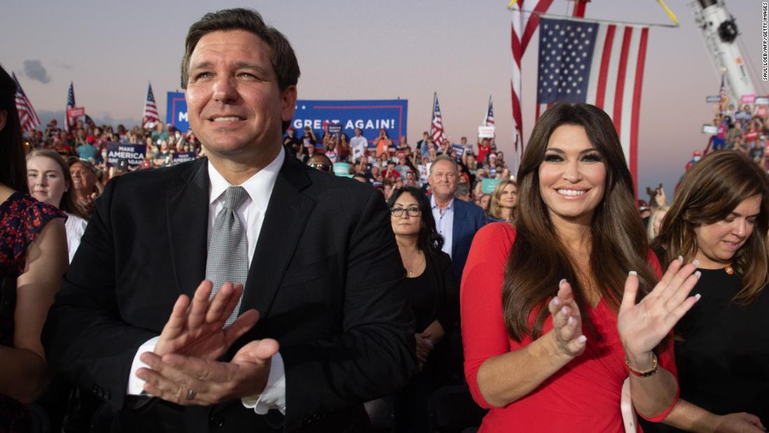 DeSantis and Kimberly Guilfoyle, the finance chairwoman of Trump&#39;s campaign, applaud during a Trump rally in Sanford, Florida, in October 2020.