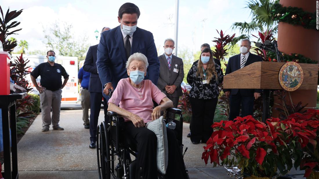 DeSantis pushes Vera Leip, 88, in her wheelchair after she received a Covid-19 vaccine in Pompano Beach, Florida, in December 2020. Leip&#39;s retirement community was one of the first in the country to receive vaccinations.