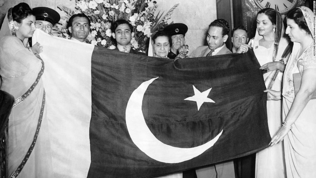A civil commission of Pakistanis presents the flag of the nation during a ceremony at Lancaster House in London, on August 15, 1947. 