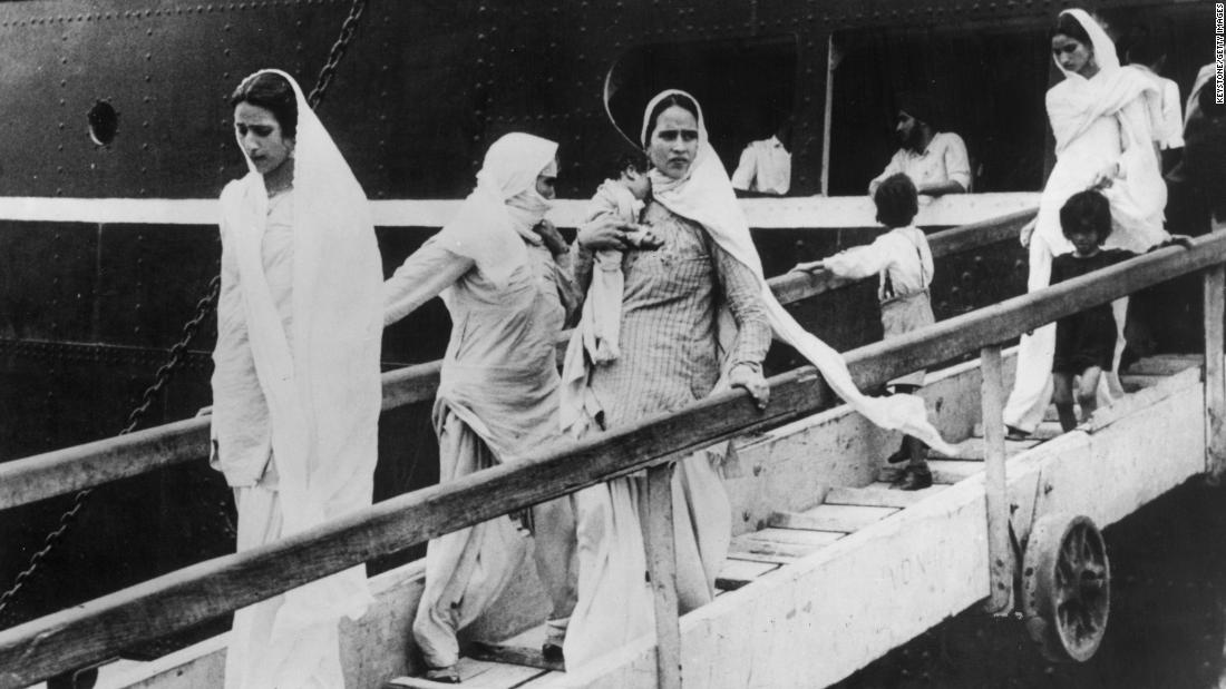 Hindu and Sikh women arrive in Bombay, now Mumbai, with their children on a British-India liner after leaving from Pakistan on October 9, 1947. 