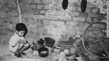 A young child in an abandoned ammunition dump in Delhi, after communal riots between Hindus and Muslims in 1947.  