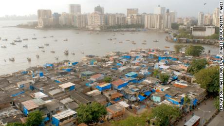 Slums line the shore near the up-market neighborhood of Cuffe Parade, Mumbai, Maharashtra, India. 