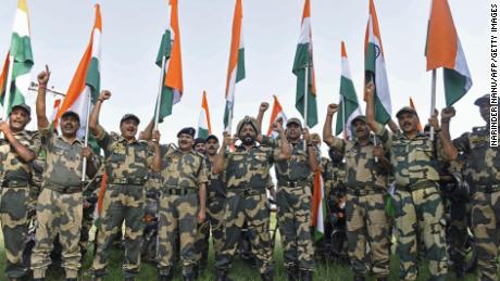 Indian Border Security Force soldiers hold the national flag during a motorbike rally ahead of the 75th anniversary of country&#39;s independence at the India-Pakistan border outpost in Panjgrain, about 60km from Amritsar on August 10, 2022.