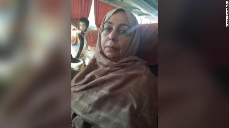 Judge Fawzia Amini is pictured on an overnight bus journey to Mazar-i-Sharif, from where she flew out of the country.