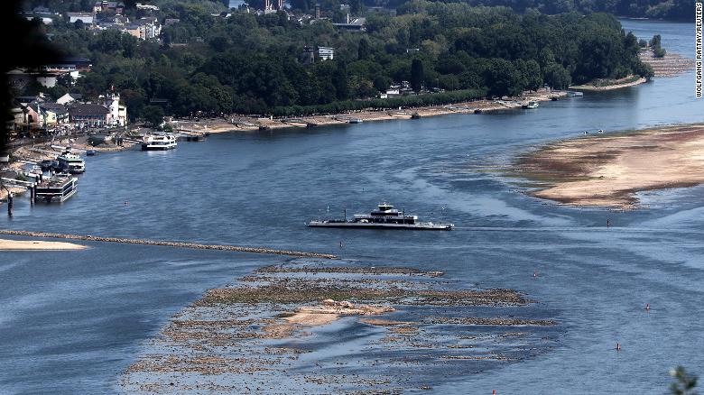 A ferry cruises past the partially dried riverbed of the Rhine river in Bingen, Germany on Aug. 9.