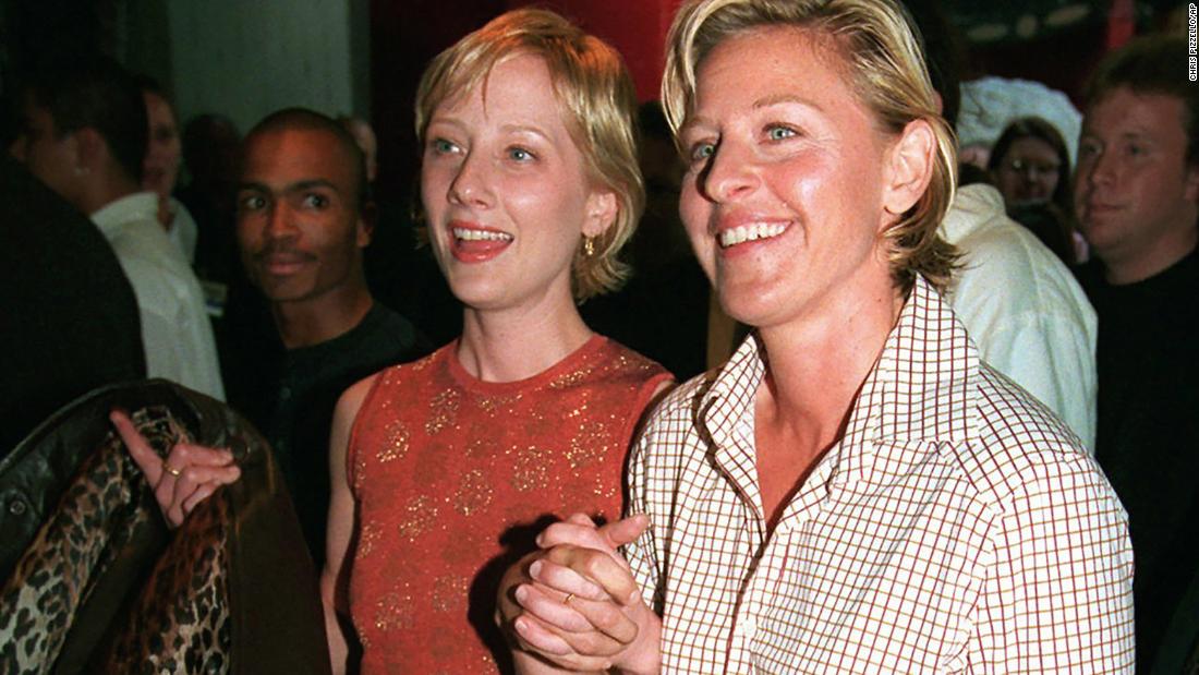 Heche, left, holds hands with comedian Ellen DeGeneres at the world premiere of the movie &quot;Face/Off&quot; in 1997. The two dated for several years.