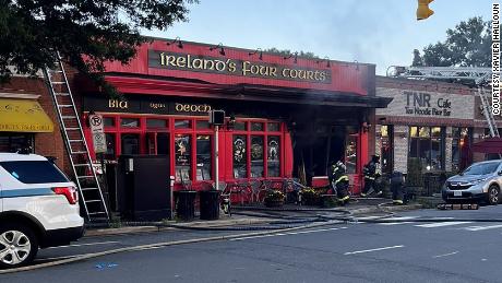 Firefighters at Ireland&#39;s Four Courts Pub in Arlington, Virginia. Police said eight people were transported to area hospitals, and six others treated at the scene after being injured when a vehicle crashed into the building.
