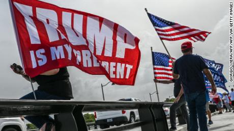 Supporters of former US President Donald Trump gather near his residence at Mar-A-Lago in Palm Beach, Florida, on August 9, 2022. - Former US President Donald Trump said on August 8, 2022, that his Mar-A-Lago residence in Florida was being &quot;raided&quot; by FBI agents in what he called an act of &quot;prosecutorial misconduct.&quot; (Photo by Giorgio VIERA / AFP) (Photo by GIORGIO VIERA/AFP via Getty Images)