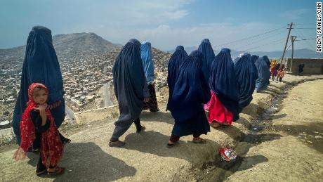 Shakeela Rahmati and other women start the three hour walk from their home in a poor neighborhood in the hills above Kabul to the city center to quietly beg for food.