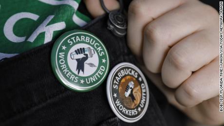 An employee in Jacksonville, Florida shows off buttons in support of unionizing Starbucks.