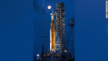 A full Moon is in view from Launch Complex 39B at NASA&#39;s Kennedy Space Center in Florida on June 14, 2022. The Artemis I Space Launch System (SLS) and Orion spacecraft, atop the mobile launcher, are being prepared for a wet dress rehearsal to practice timelines and procedures for launch. The first in an increasingly complex series of missions, Artemis I will test SLS and Orion as an integrated system prior to crewed flights to the Moon. Through Artemis, NASA will land the first woman and first person of color on the lunar surface, paving the way for a long-term lunar presence and using the Moon as a steppingstone on the way to Mars.