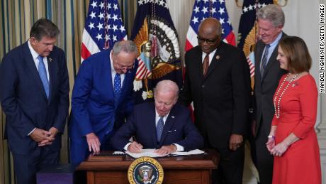 US President Joe Biden signs the Inflation Reduction Act of 2022 into law during a ceremony in the State Dining Room of the White House in Washington, DC, on August 16, 2022. (Photo by MANDEL NGAN / AFP) (Photo by MANDEL NGAN/AFP via Getty Images)