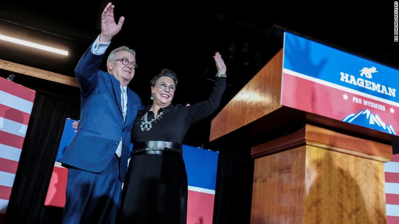 Republican congressional candidate Harriet Hageman waves along with her husband John Sundahl during her primary election night party in Cheyenne, Wyoming, U.S., August 16, 2022. 