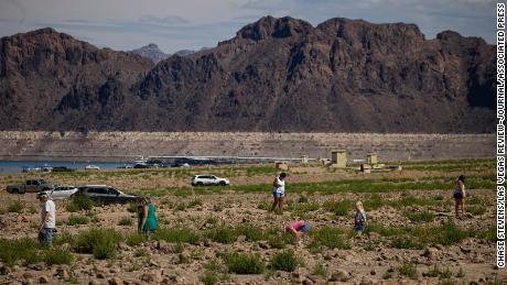 Visitors walk by Swim Beach at the Lake Mead National Recreation Area in August.