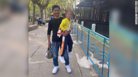 Wang Qun with his 5-year-old daughter in China.