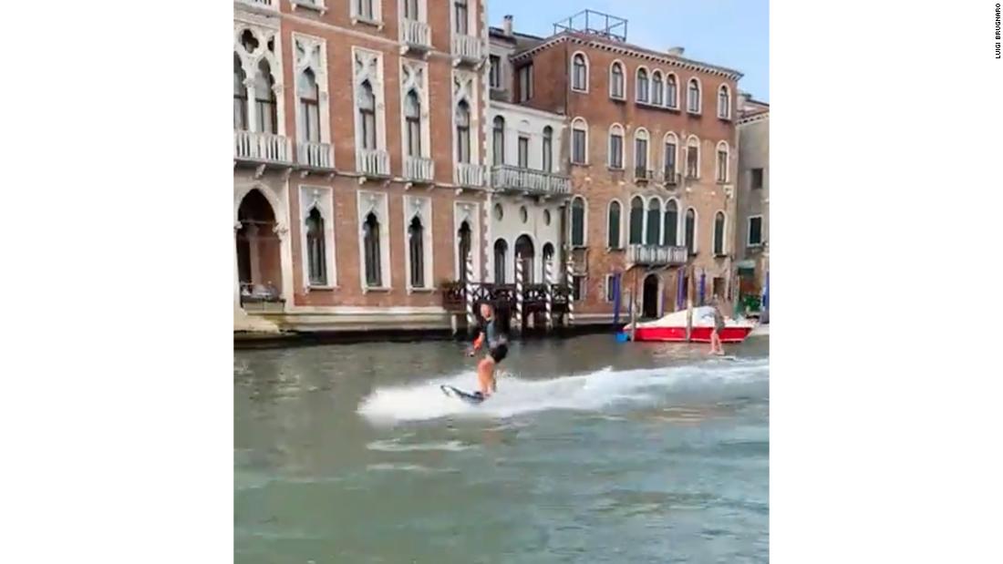 Tourists fined for surfing up Venice's Grand Canal