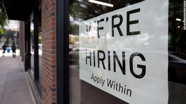 A hiring sign is seen on the window of a retail store in Washington, D.C., on August 5. 