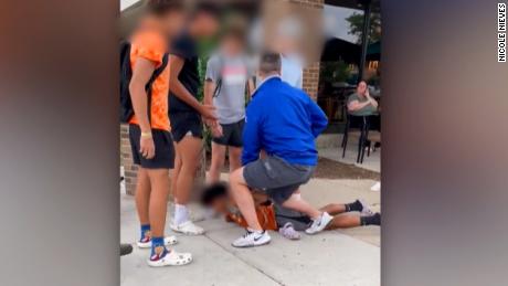 Off-duty police officer charged after video shows him kneeling on teen&#39;s back, accuses him of stealing son&#39;s bicycle. A portion of this image has been blurred to protect identities.
