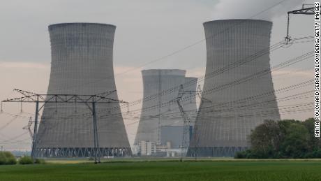 High voltage power lines and cooling towers of the Dampierre-en-Burly nuclear power plant, operated by Electricité de France SA (EDF), in Dampierre-en-Burly, France, Tuesday, May 3, 2022. EDF's The fall in nuclear production, combined with Russia's invasion of Ukraine, is exacerbating the European energy crisis, as France has traditionally been a net exporter of electricity. 
