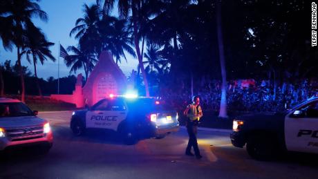Police direct traffic outside an entrance to former President Donald Trump&#39;s Mar-a-Lago estate, Monday, Aug. 8, 2022, in Palm Beach, Fla. Trump said in a lengthy statement that the FBI was conducting a search of his Mar-a-Lago estate and asserted that agents had broken open a safe. 