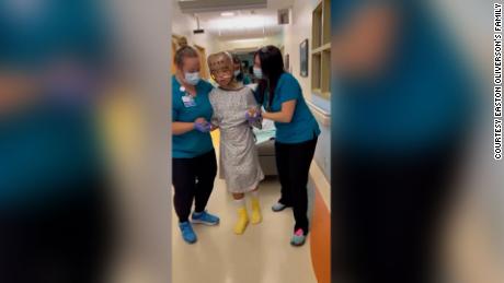Easton Oliverson's family sent CNN a video Friday of Easton walking with help from medical professionals.
