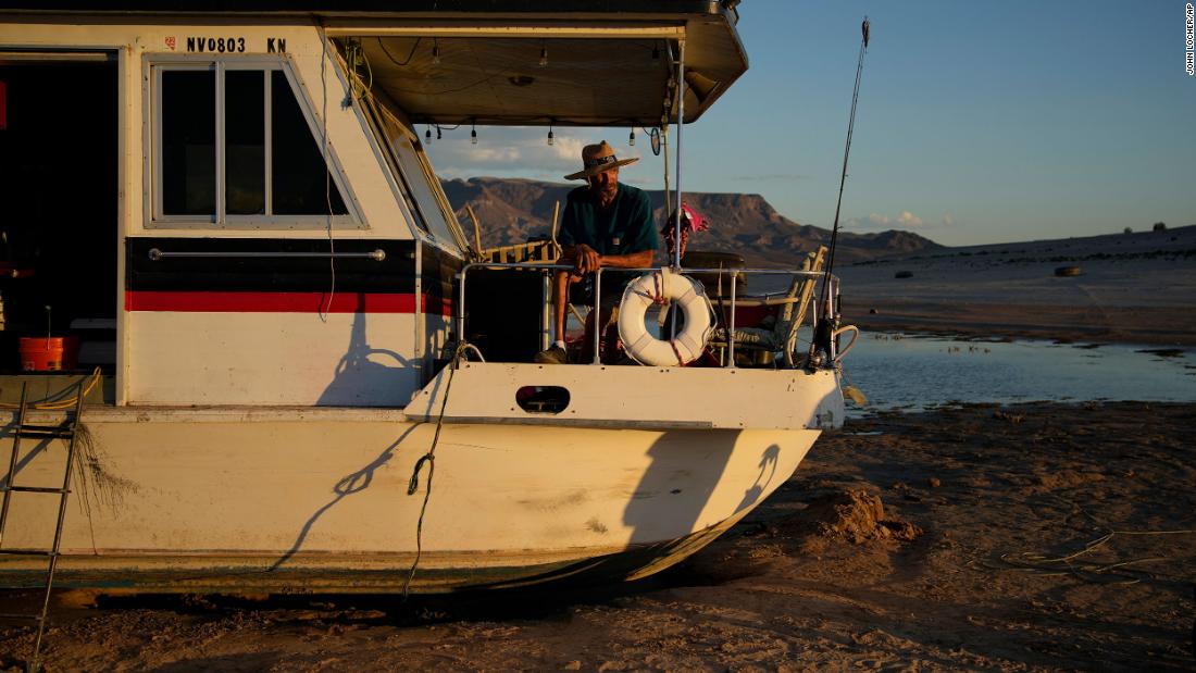 Craig Miller sits in his stranded houseboat at Lake Mead near Boulder City, Nevada, on June 23. Miller had been living on the stranded boat for over two weeks after engine trouble and falling lake levels left the boat above the water level.