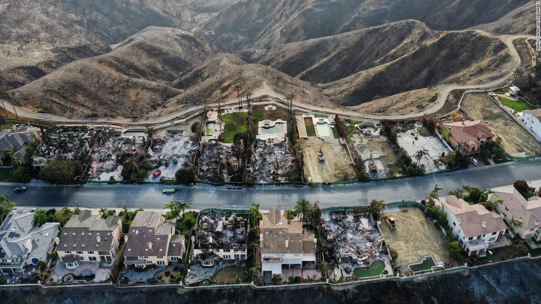 Some of the 20 hillside homes destroyed by the Coastal Fire are seen as cleanup work continues on June 17 in Laguna Niguel, California. &lt;a href=&quot;https://www.cnn.com/2022/05/11/weather/orange-county-california-fire-evacuations/index.html&quot; target=&quot;_blank&quot;&gt;The May 11 brush fire&lt;/a&gt; was fueled by windy and dry conditions amid California&#39;s severe drought, which has been compounded by climate change. Flames raced up the hill to reach the multimillion-dollar houses after the fire started below in a nearby canyon.