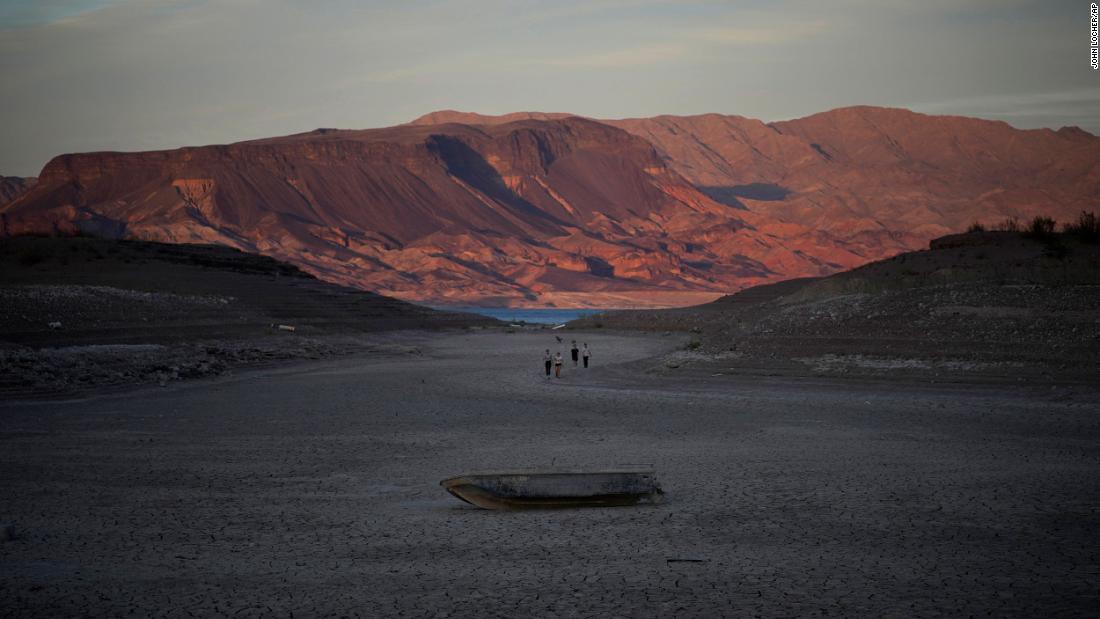 A formerly sunken boat sits on cracked earth hundreds of feet from what is now the shoreline on Lake Mead near Boulder City, Nevada, on May 9. According to a new projection from the Department of the Interior, Lake Mead&#39;s water level will be below 1,050 feet above sea level in January -- the threshold required to declare a &lt;a href=&quot;https://www.cnn.com/2022/08/16/us/colorado-river-water-cuts-lake-mead-negotiations-climate/index.html&quot; target=&quot;_blank&quot;&gt;Tier 2 shortage&lt;/a&gt; starting in 2023.