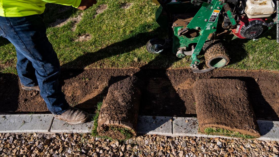 A landscaping crew removes non-functional turf from a residential development in Las Vegas on March 30. Under a Nevada state law passed last year, patches of non-functional grass that serve only for aesthetic purposes must be removed in favor of more desert-friendly landscaping.