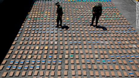 Police officers walk among packages of seized cocaine at the Pacific port of Buenaventura, Colombia.