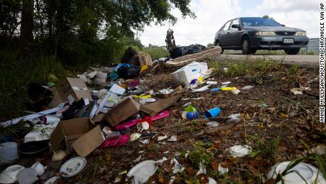 Trash fills the ditch outside of Raymond Dugas&#39; property in northeast of downtown Houston.