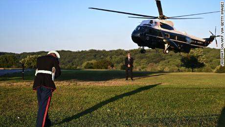 A US Marine braces against the wind as Marine One lands to pick up US President Joe Biden at Brandywine Creek State Park in Wilmington, Delaware on August 20, 2022. 