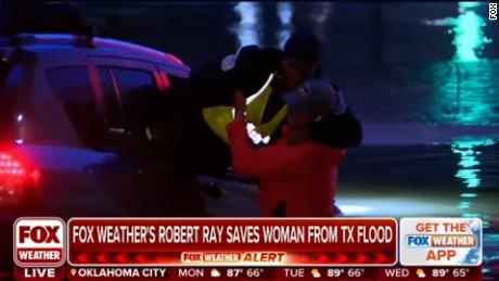 Watch weather reporter rescue woman from flood waters on air