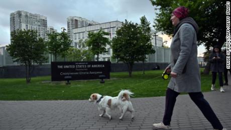 A woman walks her dog outside the US embassy in Kyiv on May 18, 2022.