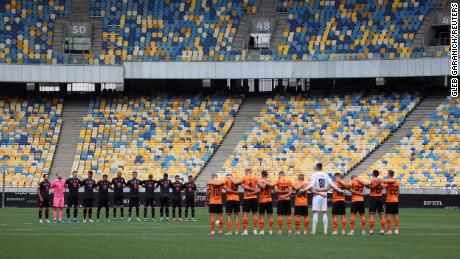 Shakhtar Donetsk and Metalist 1925 Kharkiv players during a moment of silence for those who lost their lives as Russia's attack on Ukraine continues.