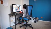 BARTLETT, ILLINOIS - MAY 01: Seven-year-old Hamza Haqqani, a 2nd grade student at Al-Huda Academy, uses a computer to participate in an E-learning class with his teacher and classmates while at his home on May 01, 2020 in Bartlett, Illinois. Al-Huda Academy, an Islam based private school that teaches pre-school through the 6th grade students, has had to adopt an E-learning program to finish the school year after all schools in the state were forced to cancel classes in an attempt to curtail the spread of the COVID-19 pandemic.  (Photo by Scott Olson/Getty Images)