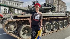 Daria, 35, wears a flower wreath on her head and holds a Ukrainian flag in Kyiv on Tuesday.