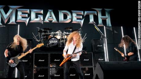 Megadeth's James Lomenzo, Dave Mustaine, and Kiko Loureiro perform on stage at a concert in Austin, Texas on August 20, 2021. 