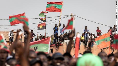 Supporters of the Angolan opposition party UNITA wave party flags during a campaign rally. 