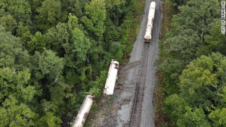 Two train cars carrying carbon dioxide became detached and rolled into the embankment near Brandon, Mississippi.