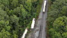 Two train cars carrying carbon dioxide broke loose and rolled onto the embankment near Brandon, Mississippi.