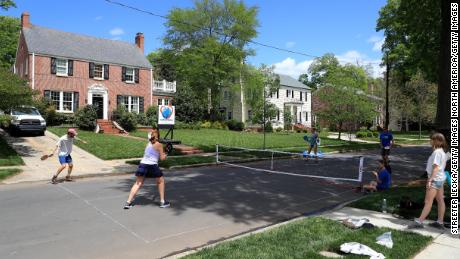 People play pickleball on an empty street in Charlotte during the early days of the coronavirus pandemic.