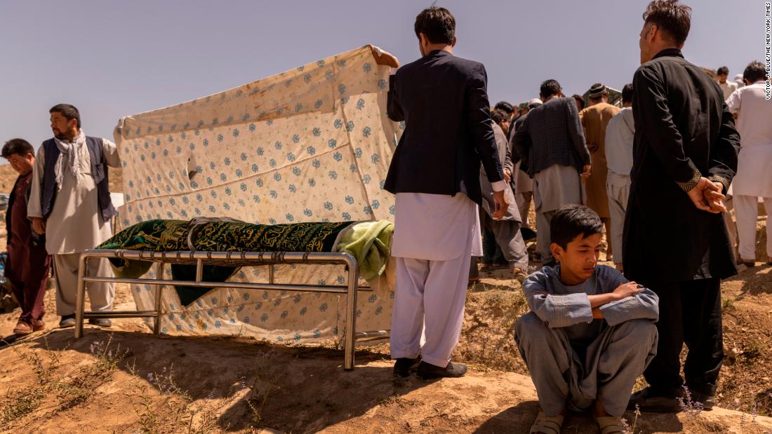Ruhullah, 16, mourns during &lt;a href=&quot;https://www.nytimes.com/2021/08/27/world/asia/afghanistan-airport-bombing-family.html&quot; target=&quot;_blank&quot;&gt;the burial of his father,&lt;/a&gt; Hussein, a former police officer who was killed in the suicide bombing at the airport in Kabul. Ruhullah survived the blast but did not know his father had died until he made his way back to his family the next day.